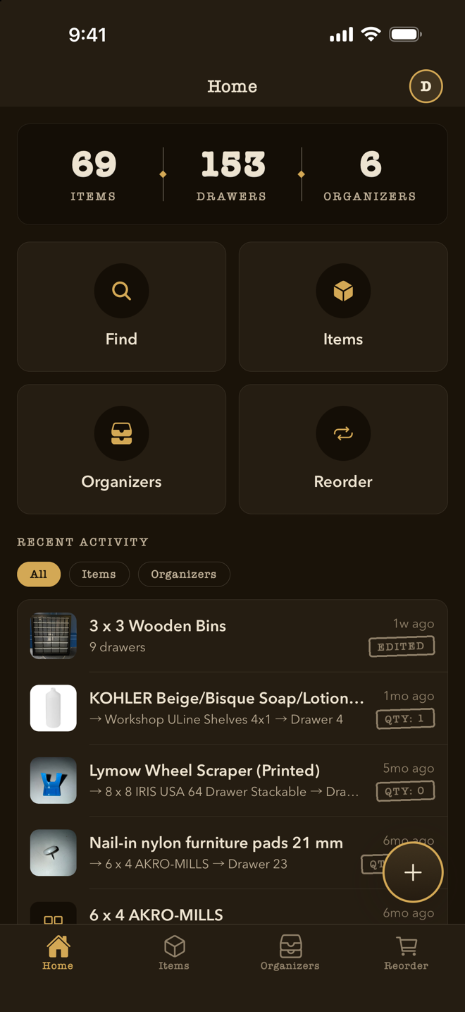 WhichDrawer 1.1 home screen in lamplit dark mode: deep warm browns with cream ink and glowing brass
